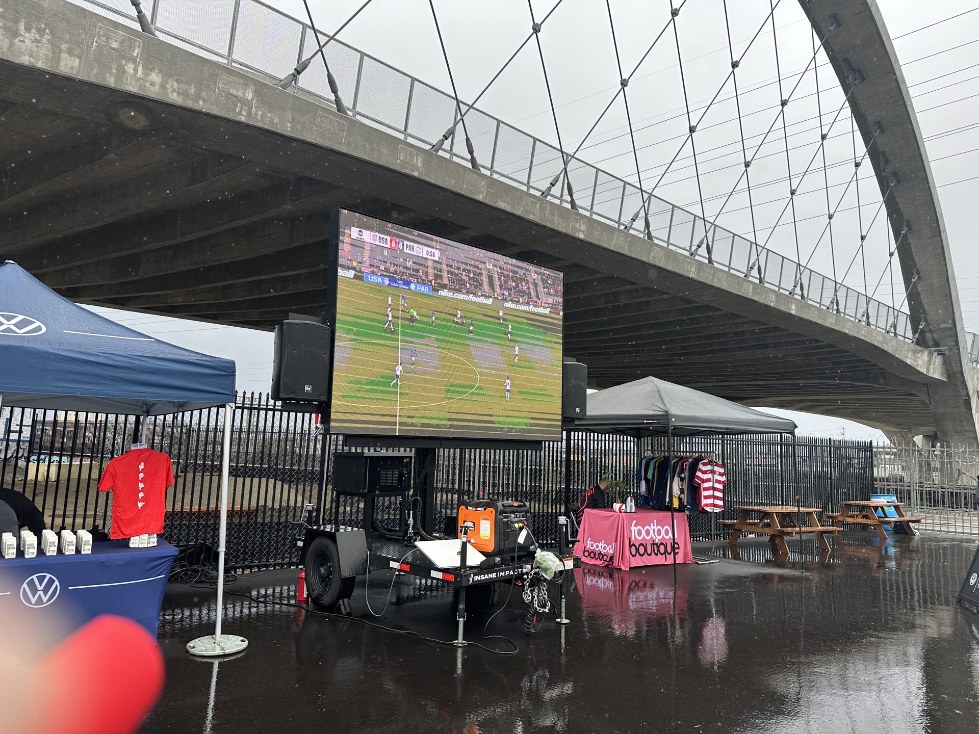 LED wall soccer watch party under a bridge